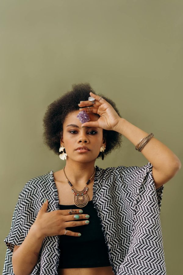 Woman in Black and White Sleeveless Top Wearing Silver Necklace