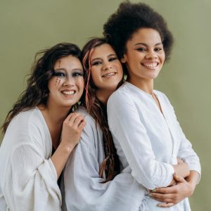 Woman in White Long Sleeve Shirt Hugging Woman in White Long Sleeve Shirt